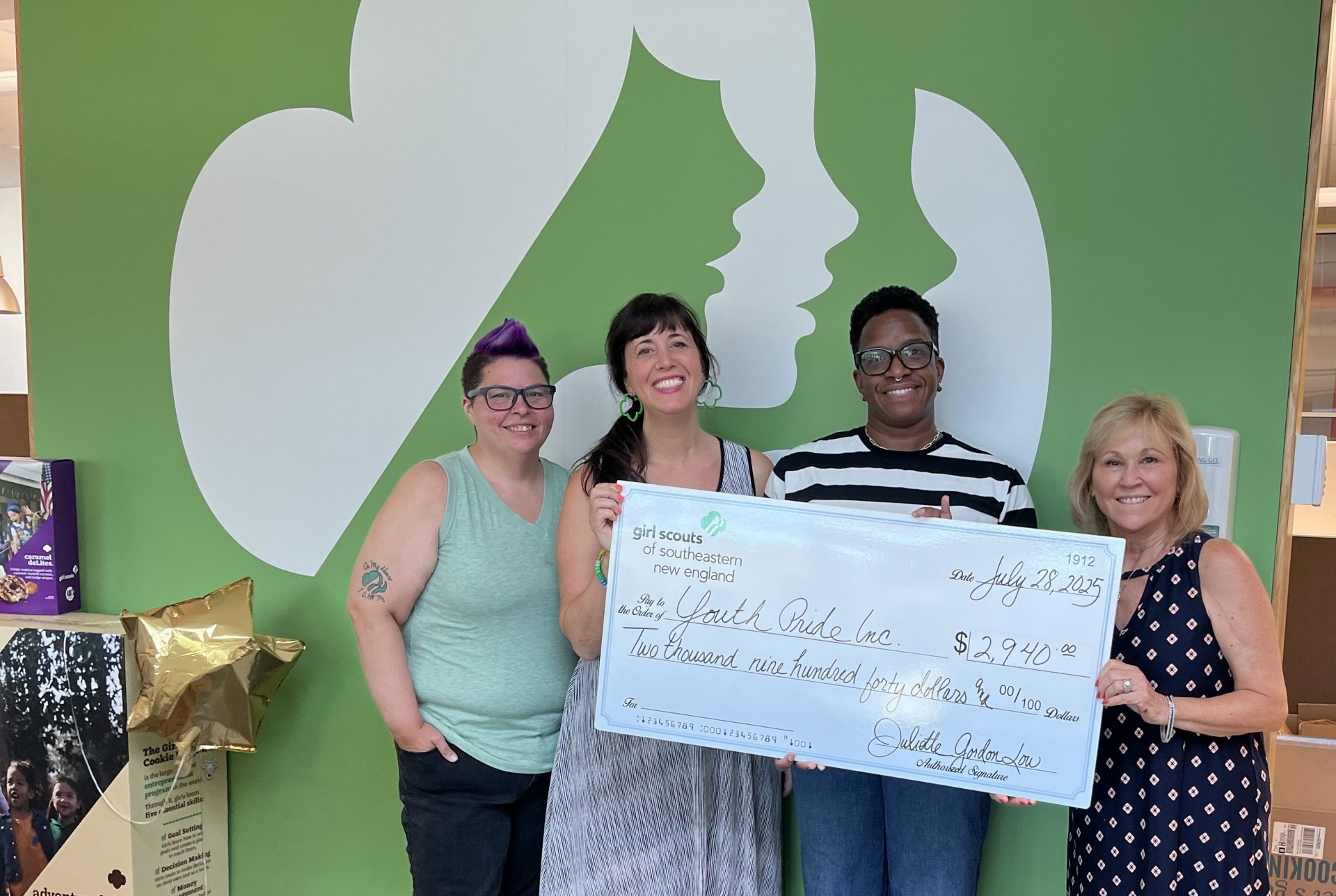 Image of GSSNE staff presenting a large check to a representative of Youth Pride Inc